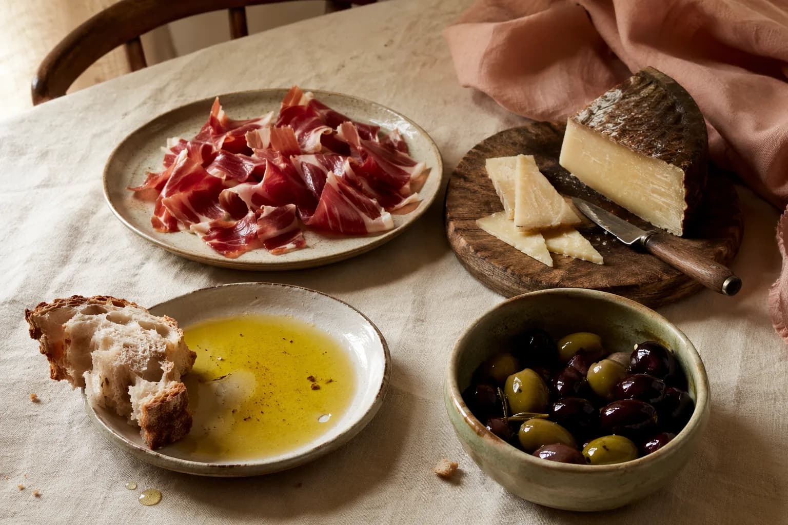 A Spanish charcuterie spread — jamón, chorizo, manchego, olives